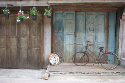 Bicycle parked on wooden wall