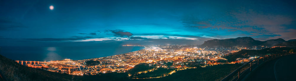 Aerial view of illuminated city against sky at night