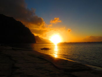 Scenic view of beach against sky during sunset