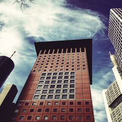 Low angle view of building against cloudy sky