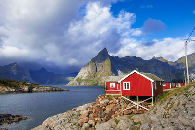 Scenic view of sea and mountains against sky