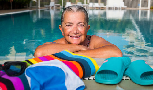 Portrait of smiling senior woman in swimming pool