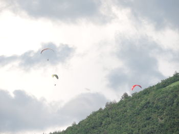 People paragliding against sky