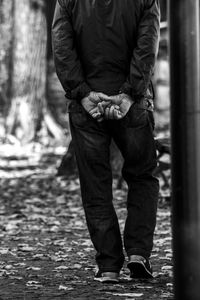 Low section of man standing on land