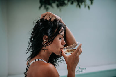 Portrait of a woman in a drinking glass