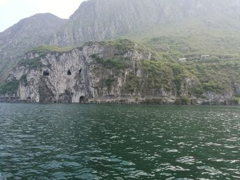 Scenic view of lake by mountain against sky