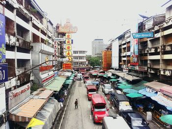 High angle view of traffic on road amidst buildings in city