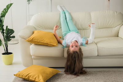 Young woman lying down on sofa at home