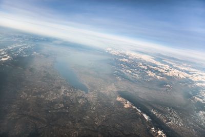 Aerial view of sea and landscape against sky