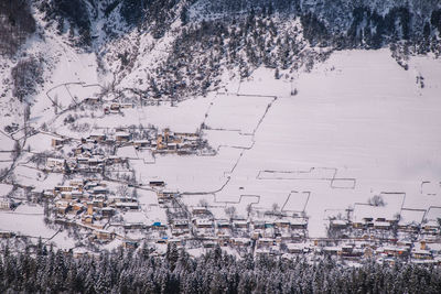 High angle view of trees and buildings during winter