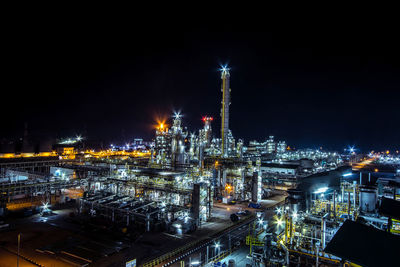 High angle view of illuminated buildings against sky at night