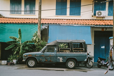 Car on street against buildings