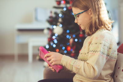 Girl using digital tablet at home during christmas