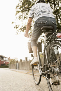 Low angle view of senior woman cycling on road