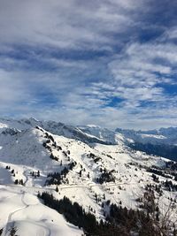 Scenic view of snowcapped mountains against sky