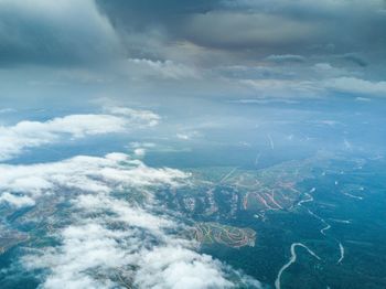 Aerial view of sea and landscape against sky