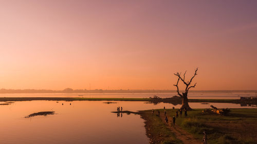 Scenic view of lake against sky during sunset