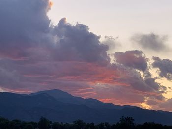 Scenic view of silhouette mountains against sky at sunset