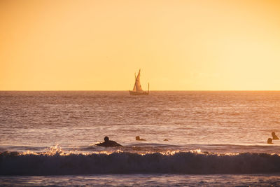 Scenic view of sea against clear sky during sunset
