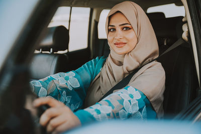 Portrait of woman sitting in car