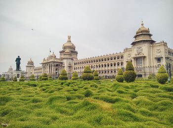 View of buildings in garden against sky