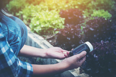 Midsection of woman holding mobile phone