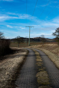 Road amidst trees against sky