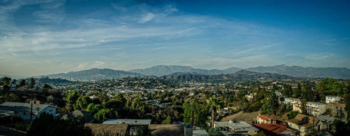 Panoramic view of trees and mountains against sky