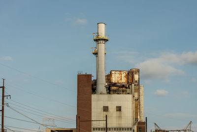 Low angle view of smoke stack against sky