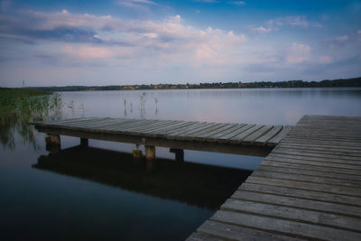 Pier over lake against sky