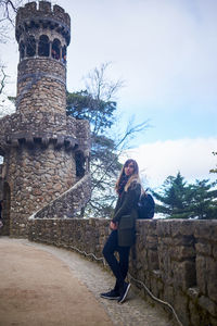 Full length of woman against historic building against sky