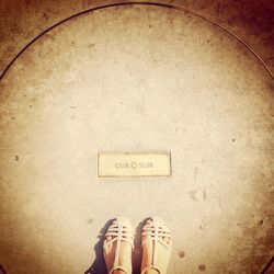 Low section of woman standing on tiled floor