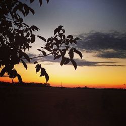 Silhouette landscape against sky at sunset