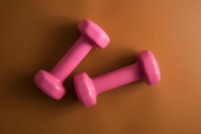 High angle view of pink toy against colored background