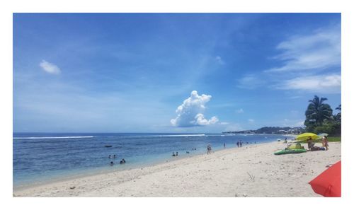 Scenic view of beach against blue sky