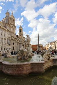 Sunny view of piazza navona with the moor fountain or fontana del moro and tourists