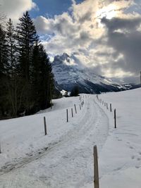 Scenic view of snow covered field against sky