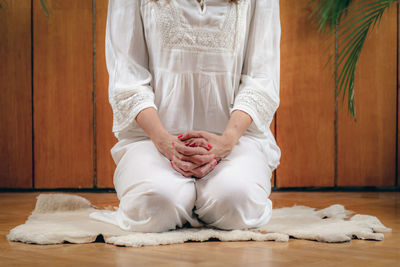 Woman practicing kundalini yoga, kriya exercises for the navel center and bowel waste elimination