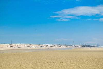 Scenic view of beach against blue sky