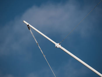 Low angle view of crane against blue sky