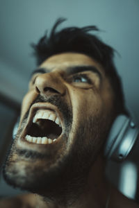 Close-up portrait of young man screaming 