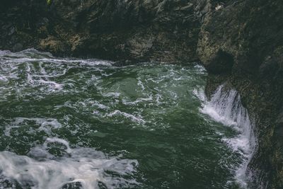 Scenic view of waterfall in sea