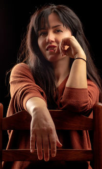 Portrait of young woman sitting outdoors