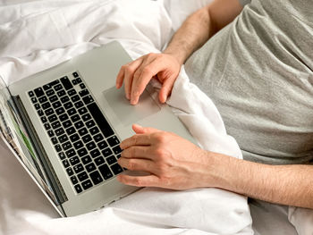 Midsection of man using laptop