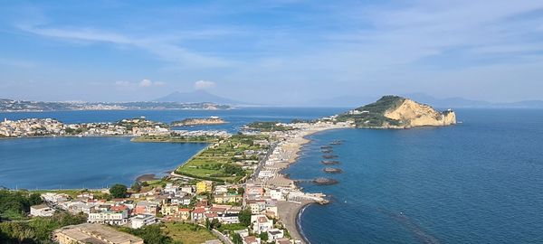 High angle view of townscape by sea against sky