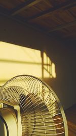 Close-up of electric fan on wall