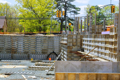 Construction site by trees in city