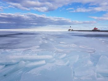 Scenic view of frozen sea against blue sky