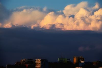 Cityscape against cloudy sky