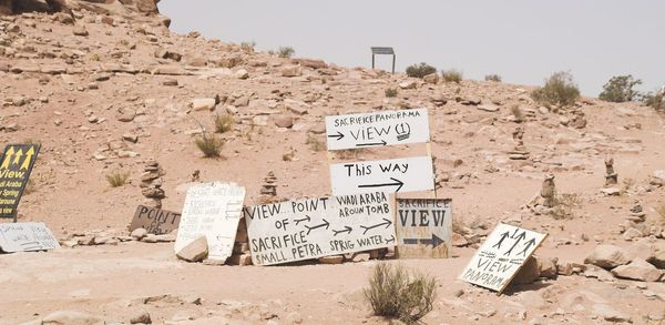 Information sign on rock against clear sky